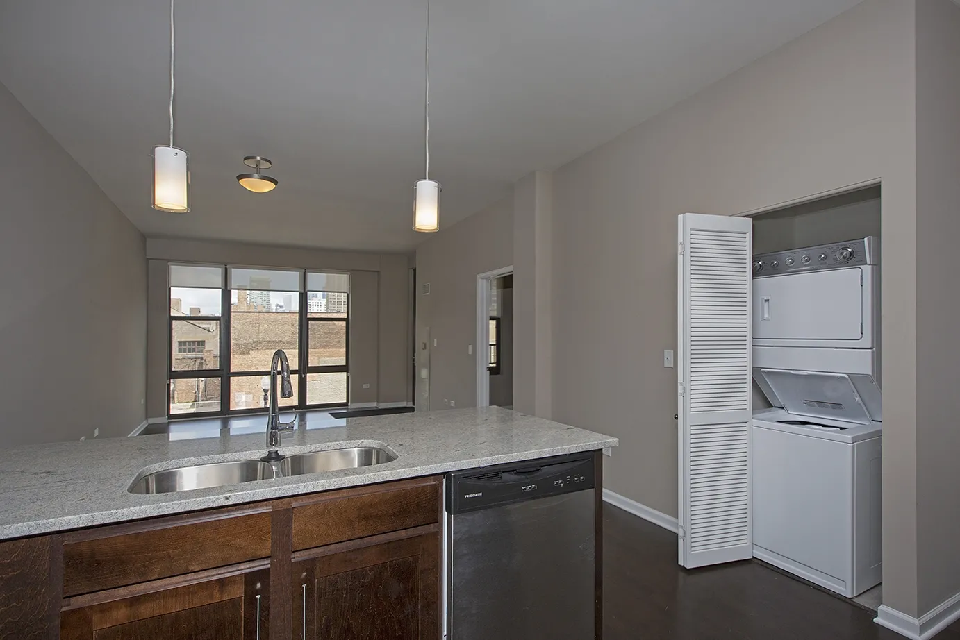 modern kitchen with brown wood cabints at The Shelby Apartments in Chicago