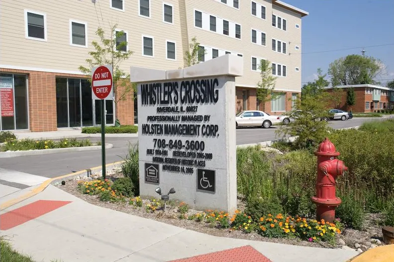 summer view of the landscaped front of Whistler Crossing Apartments