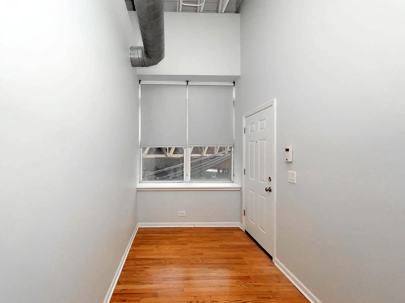 giant loft living room with wood floors at 1550 North Damen Lofts