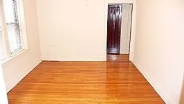 tress and brick front of 4551-4553 N Claremont Apartments