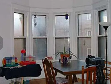 graystone facade of three story 450 W St James Place Apartments