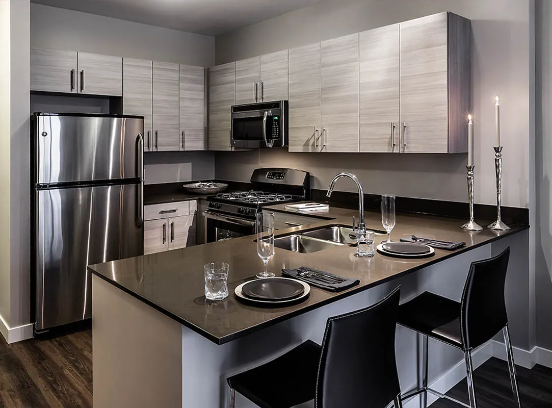 kitchen with view of living room at The Madison at Racine Apartments