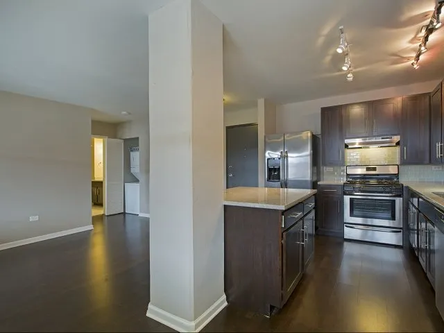 modern kitchen with brown wood cabints at The Shelby Apartments in Chicago