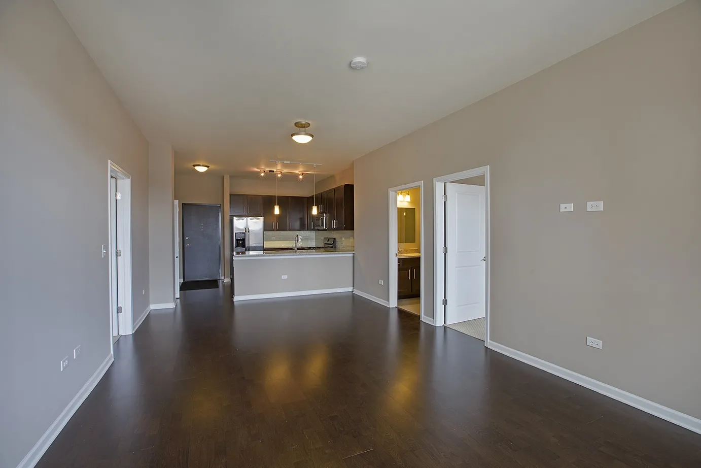 modern kitchen with brown wood cabints at The Shelby Apartments in Chicago