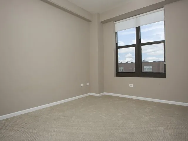 modern kitchen with brown wood cabints at The Shelby Apartments in Chicago
