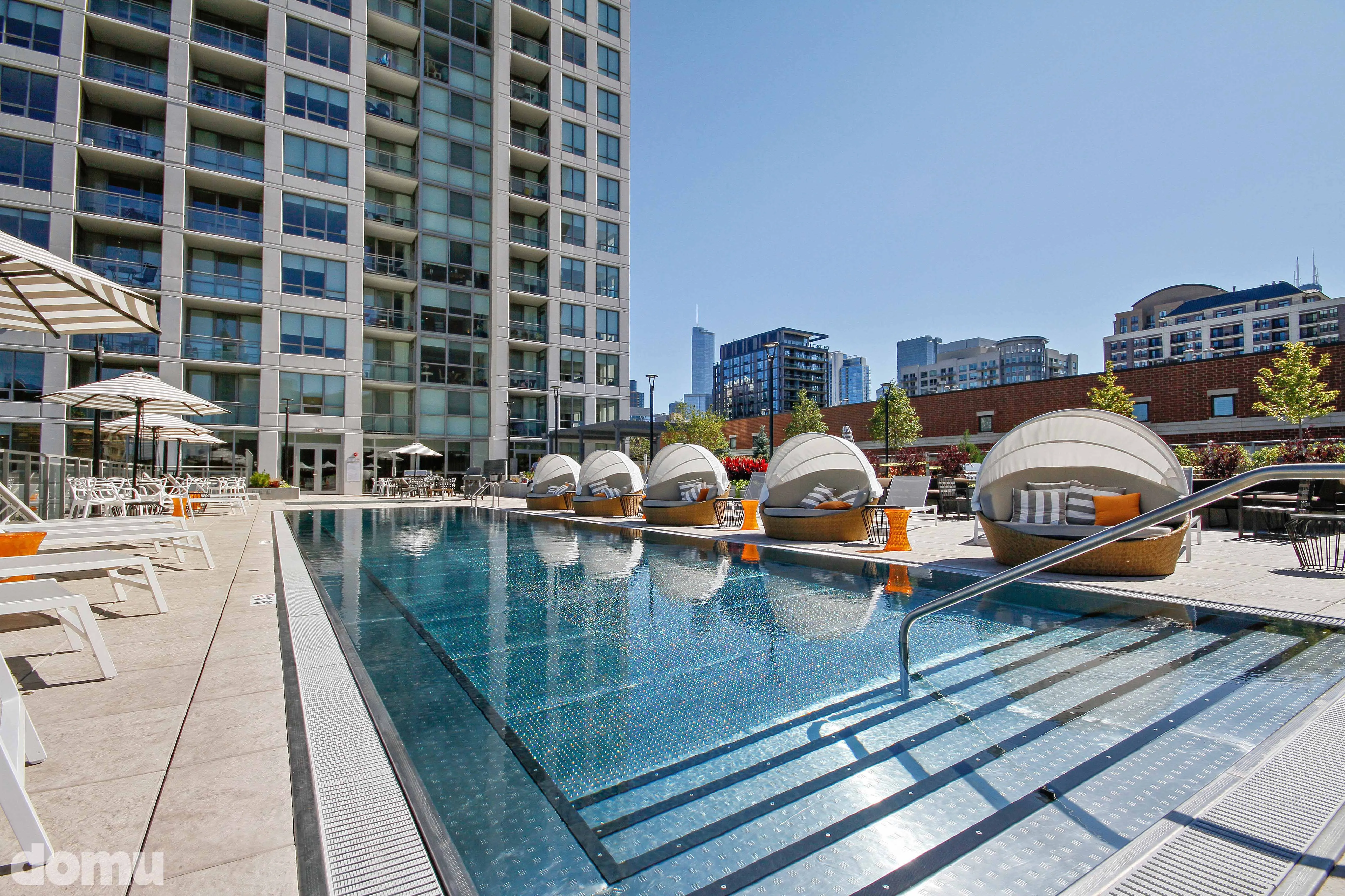outdoor pool with lounge chairs at The Hudson Apartments in Chicago