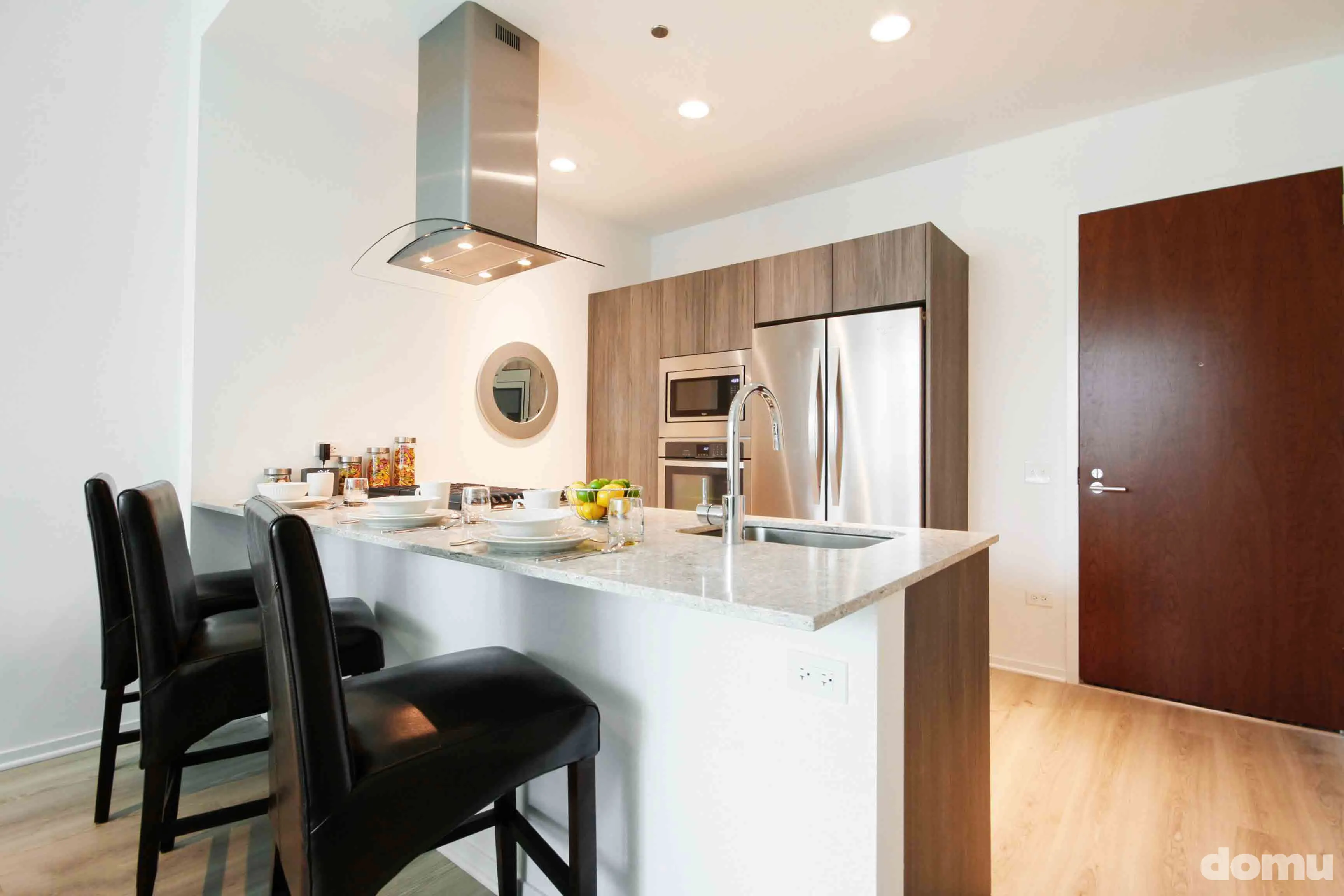 model kitchen with view of Chicago at Optima Signature Apartments