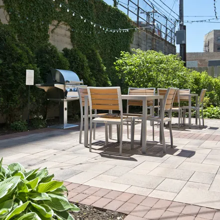 outdoor lounge space with table and plants at Reside at 823 Apartments
