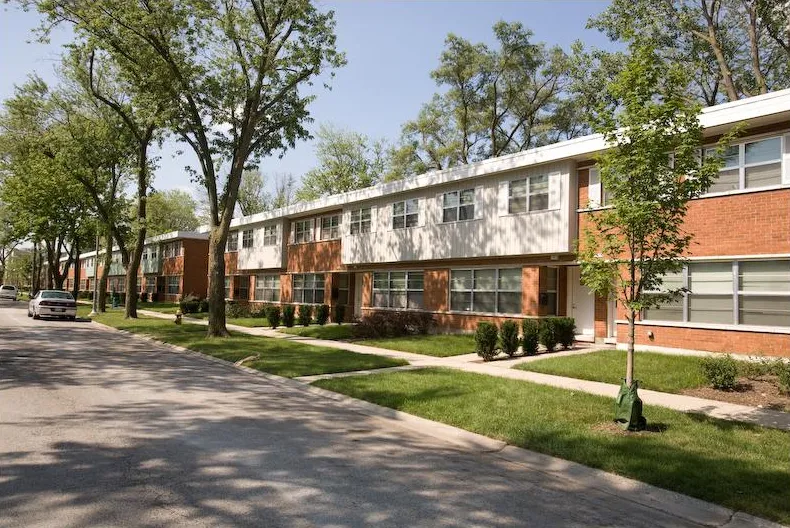summer view of the landscaped front of Whistler Crossing Apartments