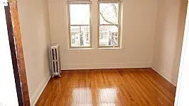 tress and brick front of 4551-4553 N Claremont Apartments