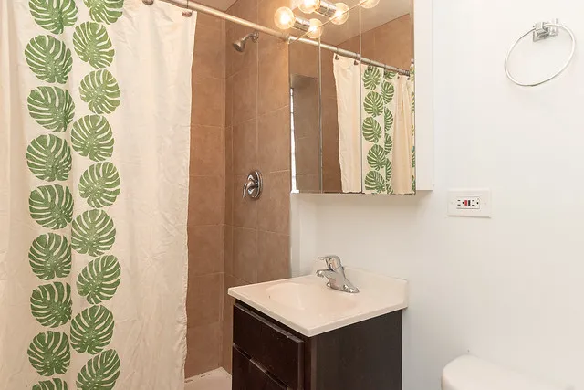 living room and kitchen view at 2244 N. Cleveland Apartments in Chicago