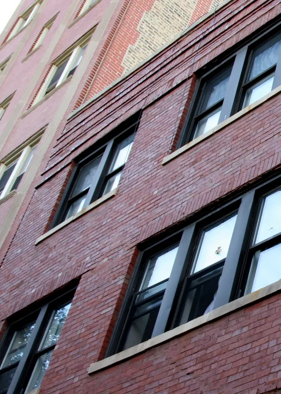 looking up at red brick exterior of 5736 North Winthrop Apartments 