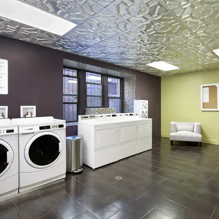 outdoor lounge space with table and plants at Reside at 823 Apartments