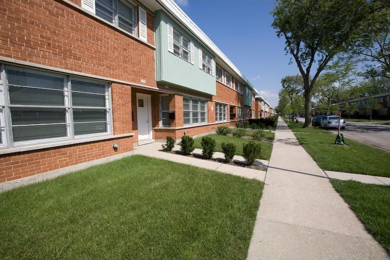 summer view of the landscaped front of Whistler Crossing Apartments