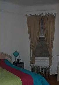 graystone facade of three story 450 W St James Place Apartments