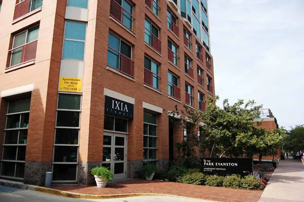 flowers surround the entrance of The Park Evanston Apartments in Evanston