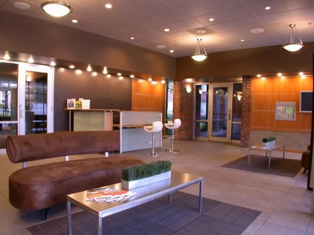 model bedroom with green wall at SCIO at the Medical District Apartments