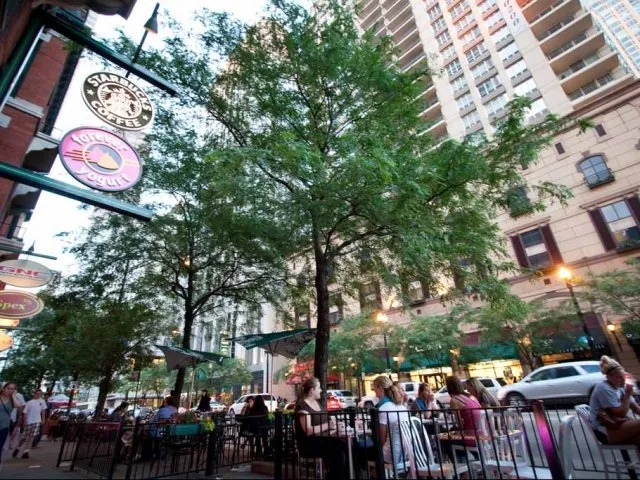 view looking up at The Bernardin Apartments with car traffic
