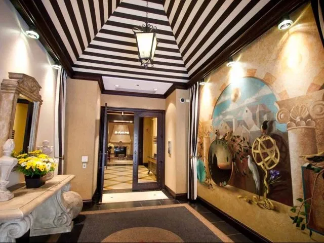 view looking up at The Bernardin Apartments with car traffic