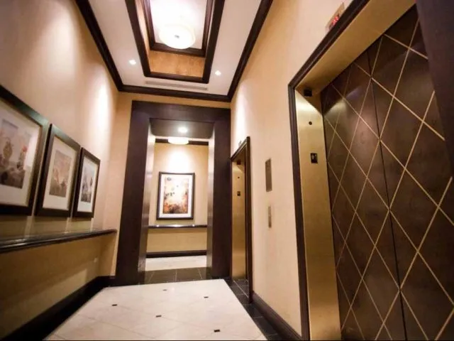 view looking up at The Bernardin Apartments with car traffic