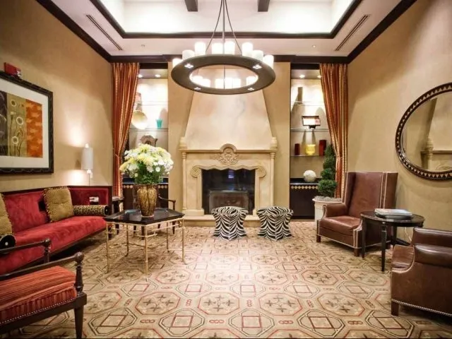 view looking up at The Bernardin Apartments with car traffic