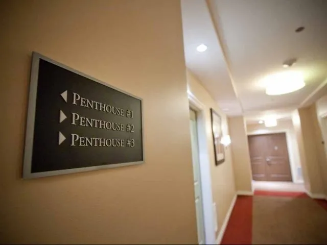 view looking up at The Bernardin Apartments with car traffic