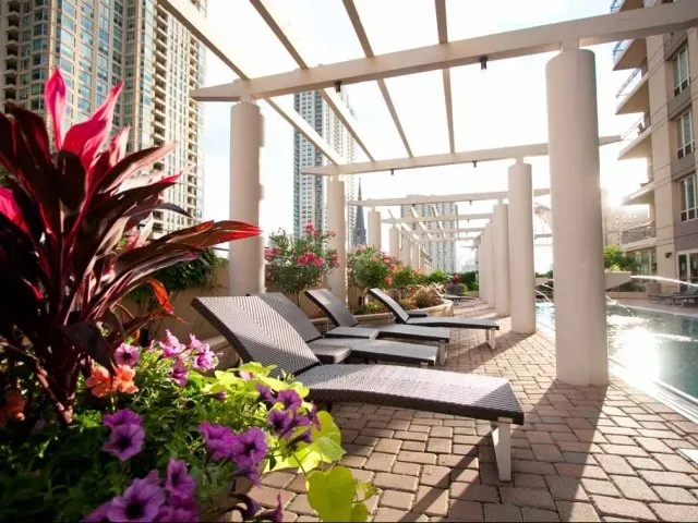 view looking up at The Bernardin Apartments with car traffic