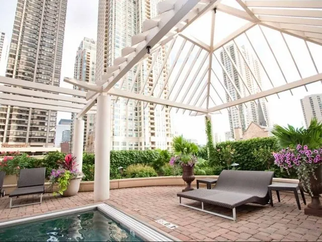 view looking up at The Bernardin Apartments with car traffic