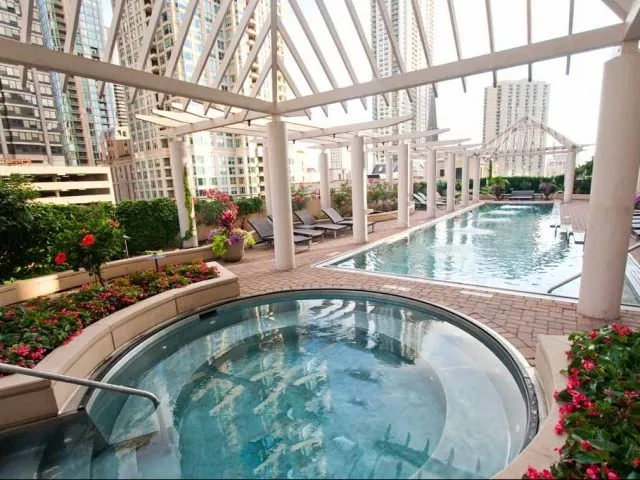 view looking up at The Bernardin Apartments with car traffic