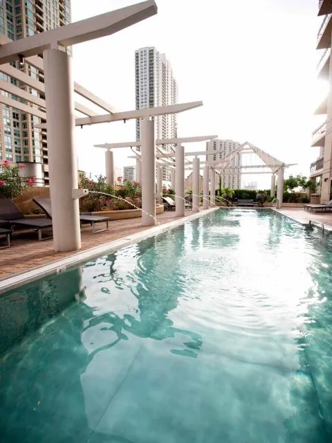 view looking up at The Bernardin Apartments with car traffic