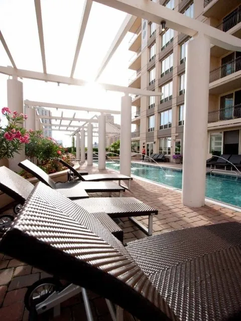 view looking up at The Bernardin Apartments with car traffic