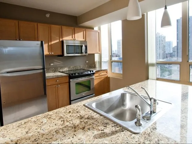 view looking up at The Bernardin Apartments with car traffic