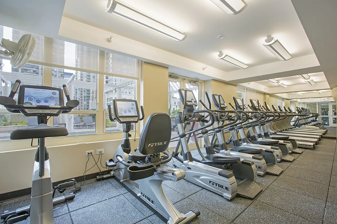 view looking up at The Bernardin Apartments with car traffic