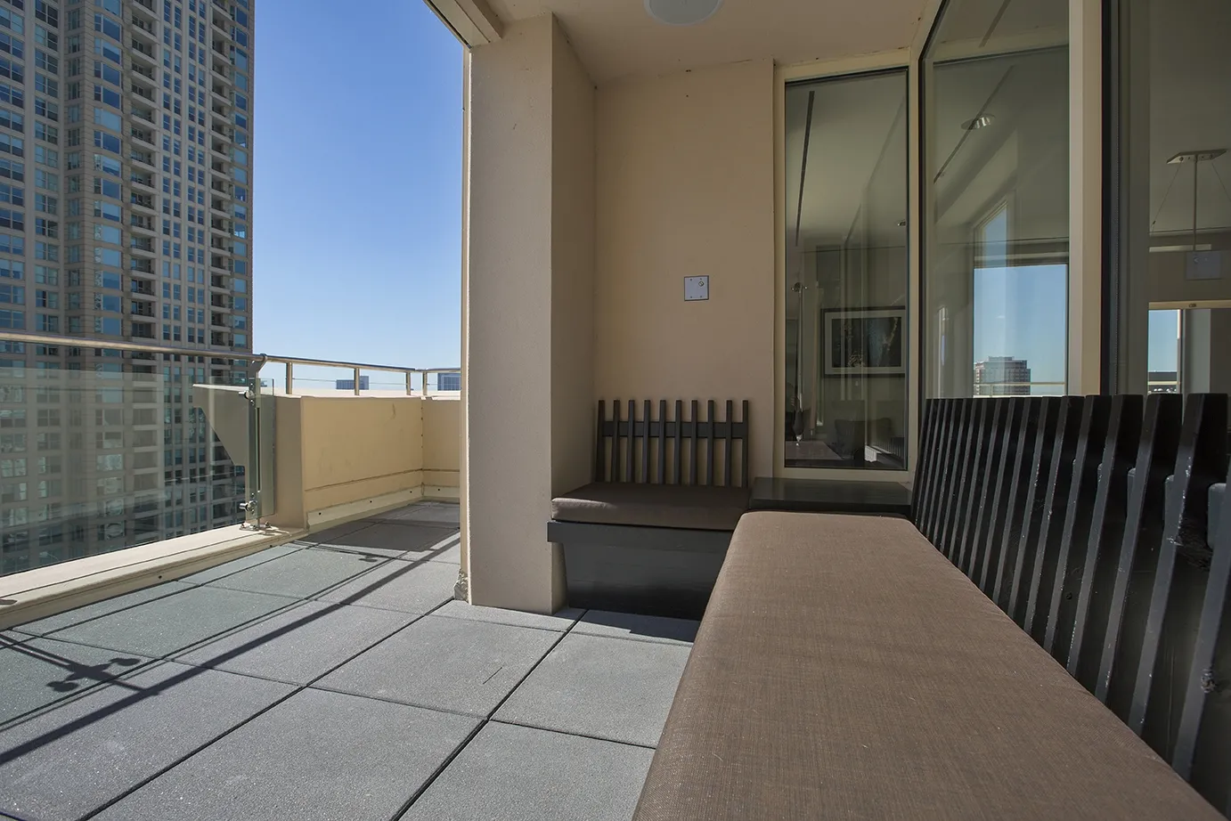 view looking up at The Bernardin Apartments with car traffic