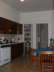 graystone facade of three story 450 W St James Place Apartments