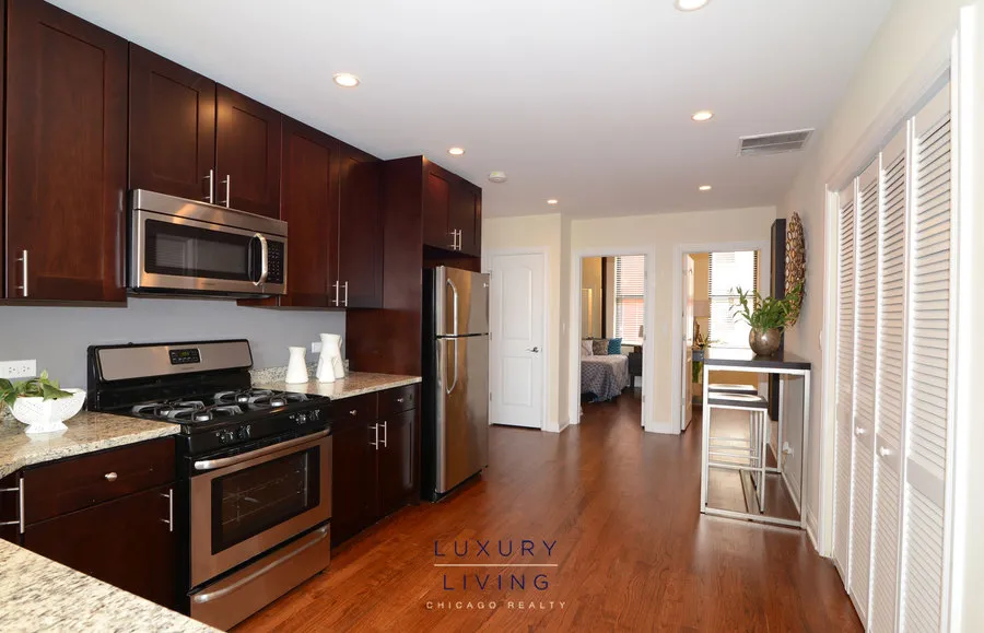 kitchen and island with wood floors at Riverview Terrace Apartments