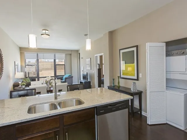 modern kitchen with brown wood cabints at The Shelby Apartments in Chicago