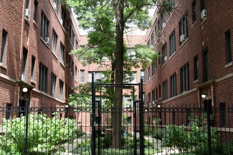 metal gate and landscaped courtyard at The Edward Apartments