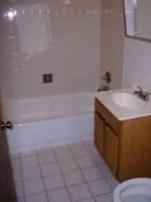 the grass and landscaped courtyard of The Dickens Courtyard Apartments