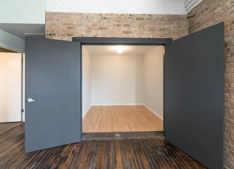 model kitchen with timber ceiling and brick wall- 1012 West Randolph Lofts