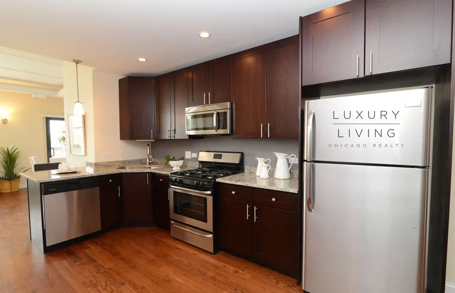 kitchen and island with wood floors at Riverview Terrace Apartments