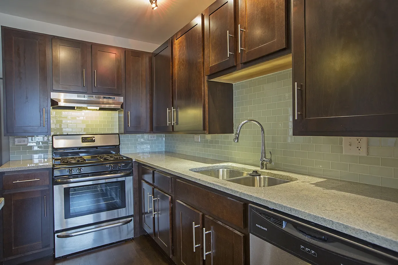 modern kitchen with brown wood cabints at The Shelby Apartments in Chicago