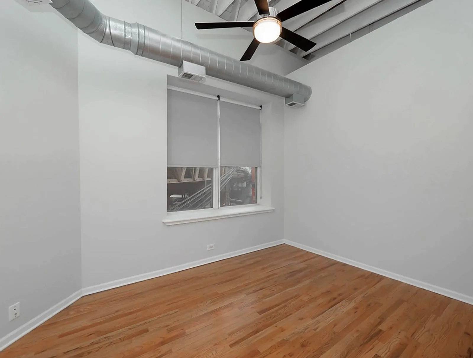 giant loft living room with wood floors at 1550 North Damen Lofts