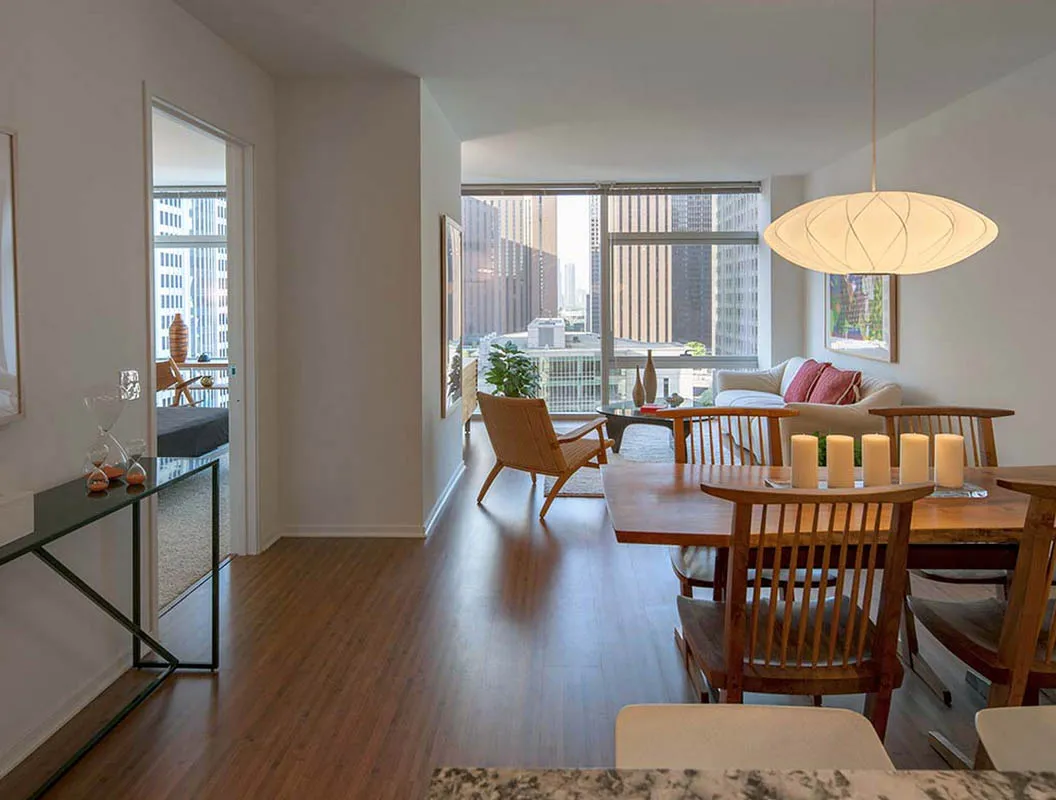 living room with wood floors and downtown view at Aston Chicago Apartments