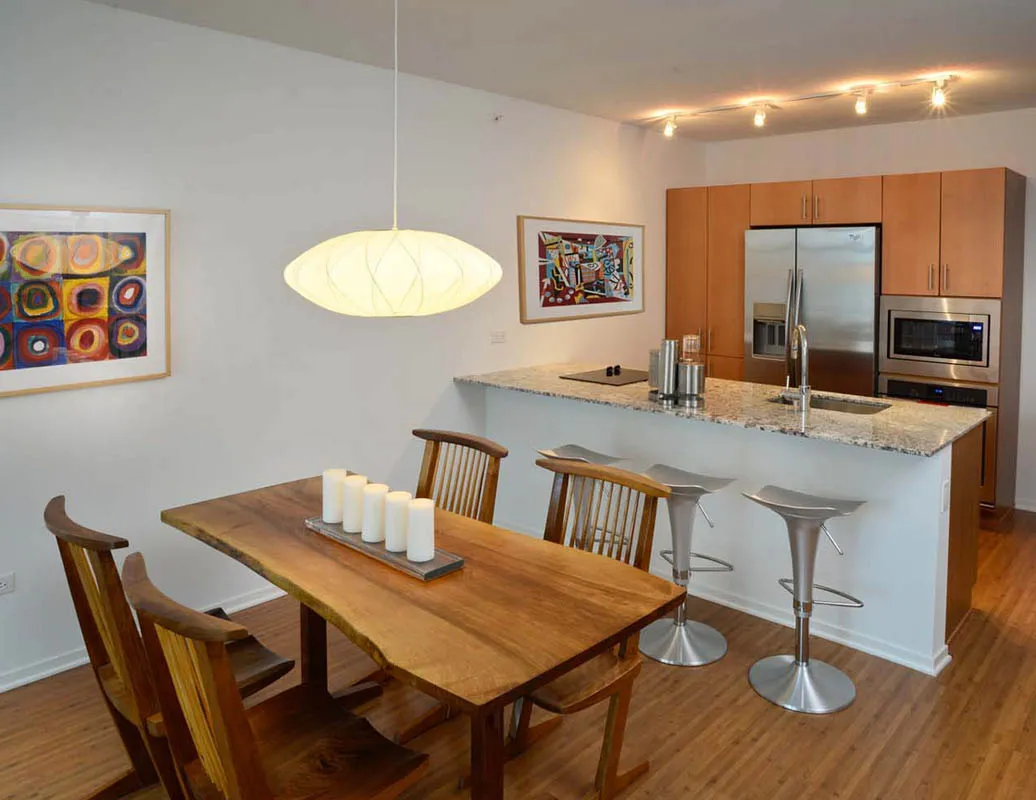 living room with wood floors and downtown view at Aston Chicago Apartments