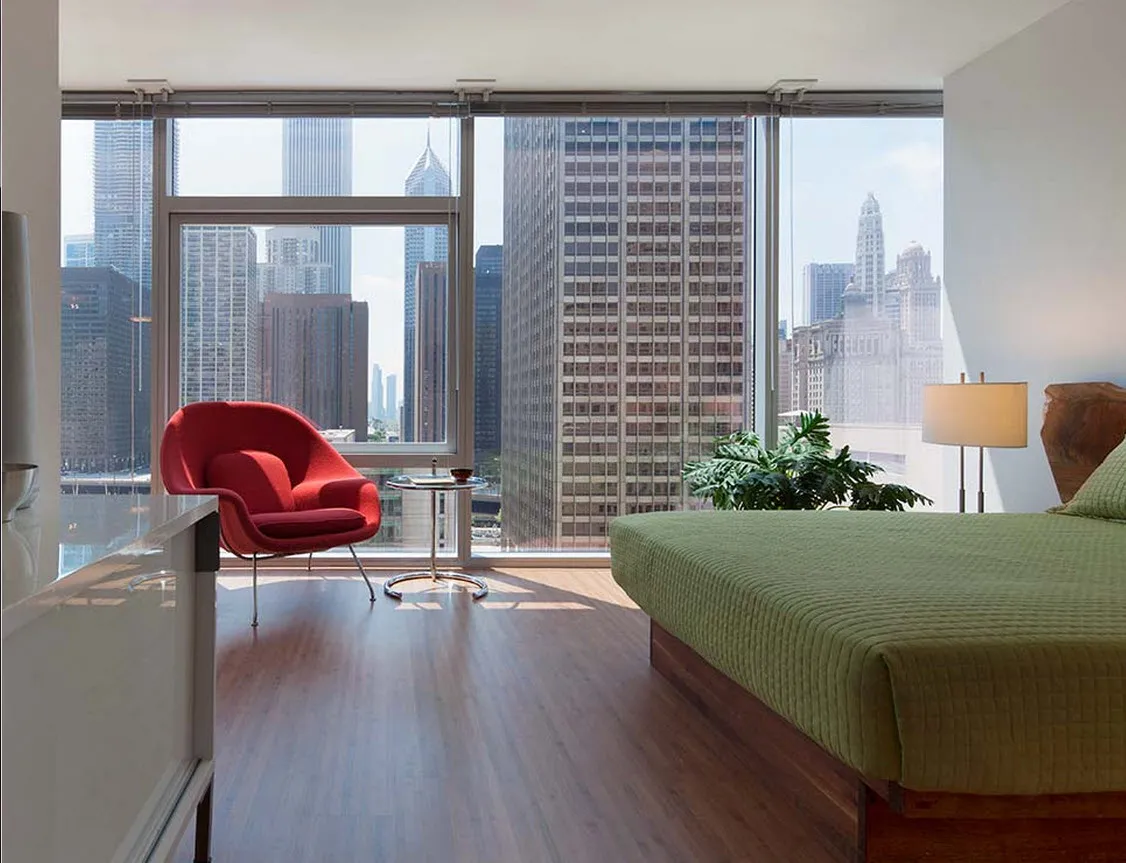 living room with wood floors and downtown view at Aston Chicago Apartments