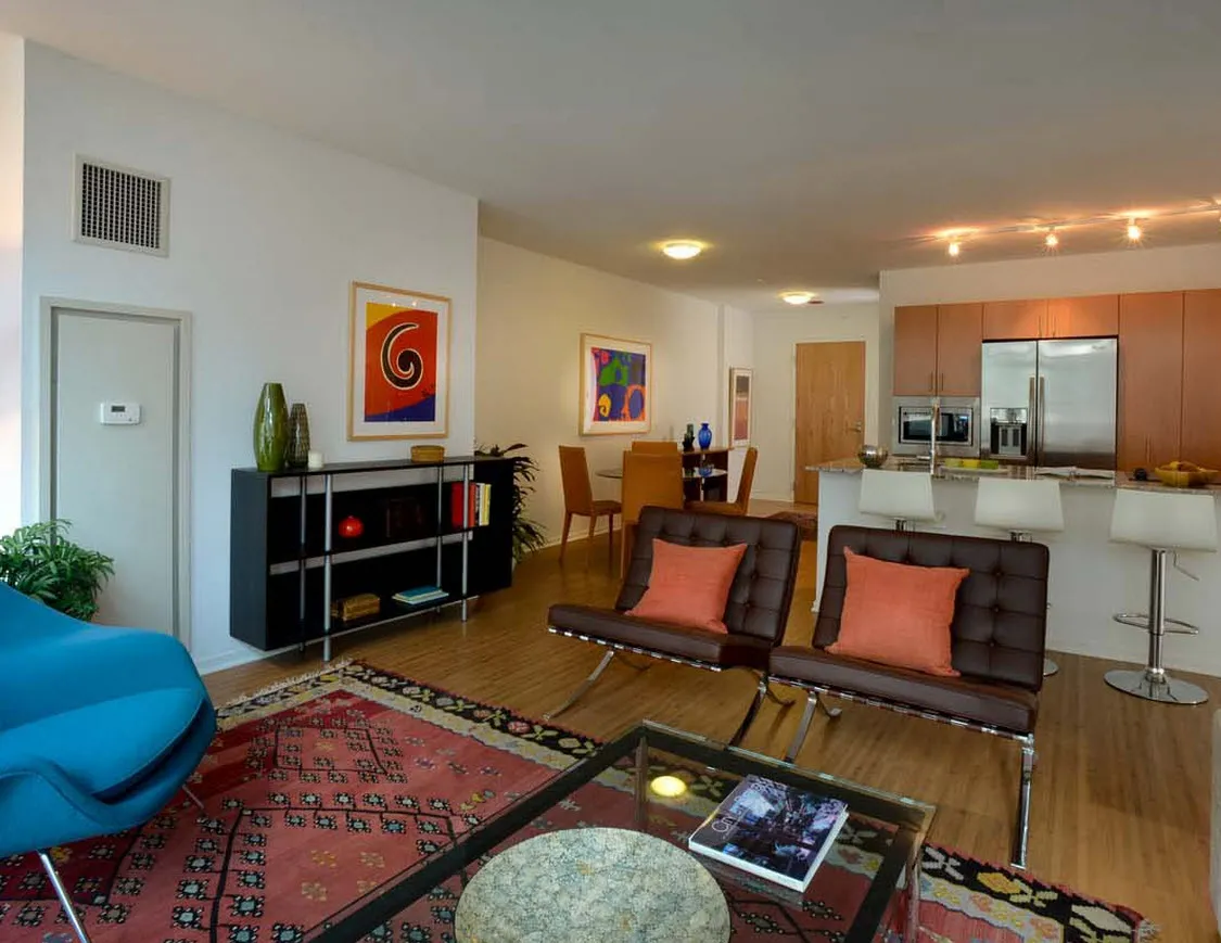 living room with wood floors and downtown view at Aston Chicago Apartments