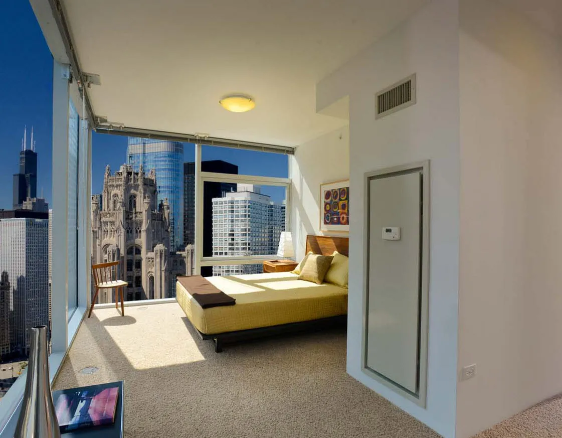 living room with wood floors and downtown view at Aston Chicago Apartments