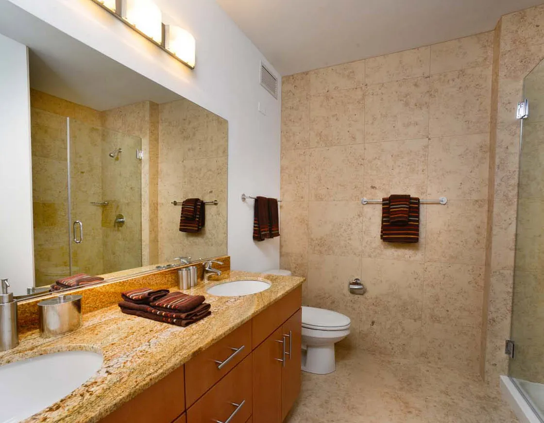living room with wood floors and downtown view at Aston Chicago Apartments