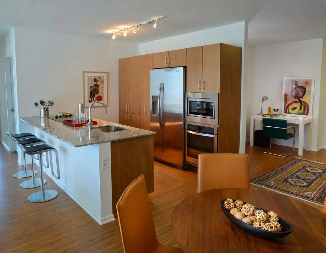 living room with wood floors and downtown view at Aston Chicago Apartments